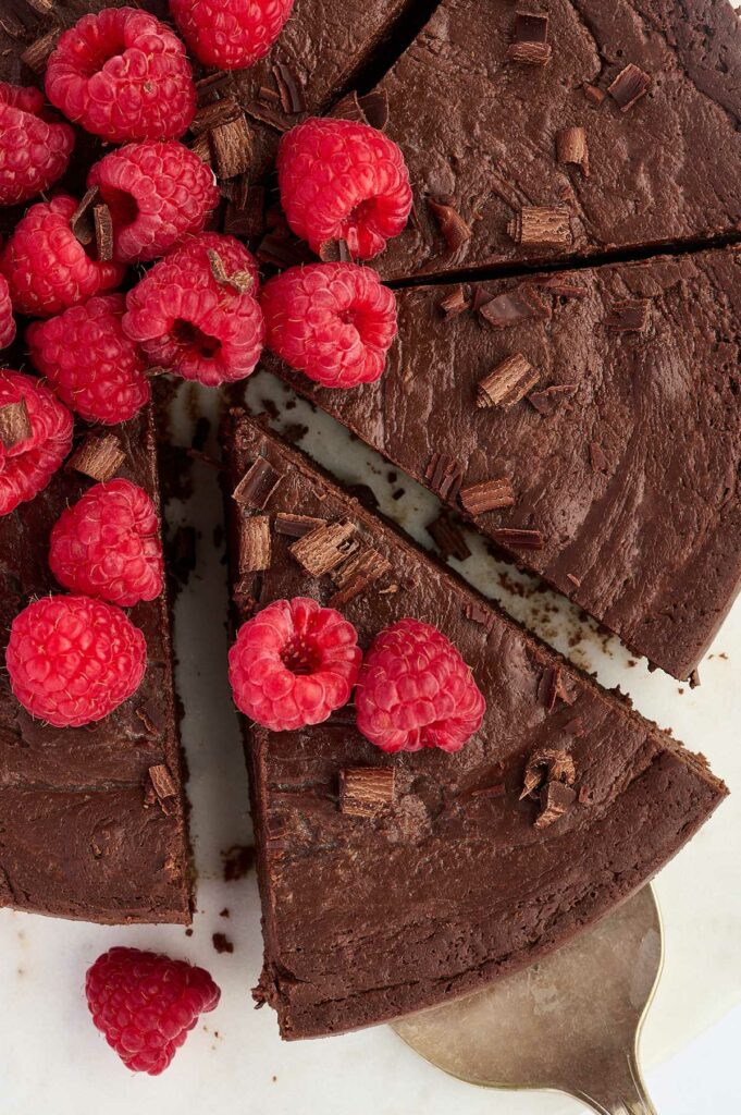 Overhead view of a sliced chocolate torte.