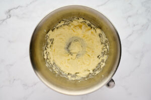 Beating the butter in a mixing bowl.
