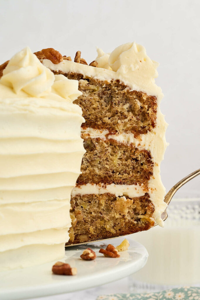 Serving a slice of hummingbird cake with a cake spatula.