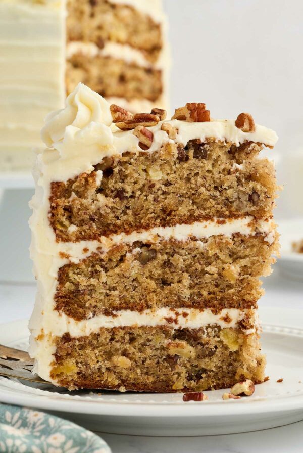 A slice of hummingbird layer cake on a white plate.