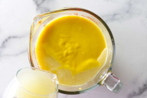 Stirring lime juice into the posset dessert.