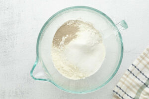 Flour, yeast and sugar in a mixing bowl.