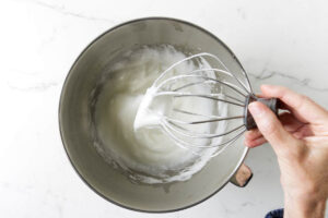 Whipping egg whites in a mixing bowl.