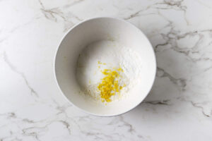 Lemon zest mixed with sugar for the blueberry cobbler biscuit topping.