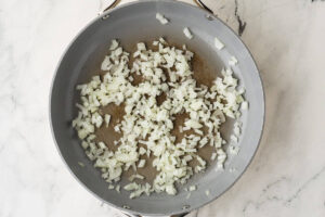 Easy cheeseburger salad recipe in a large bowl with ground beef and shredded cheddar.