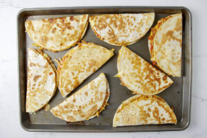 Warming chicken quesadillas in the oven.