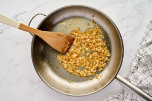 Sauteeing diced onions in a skillet.