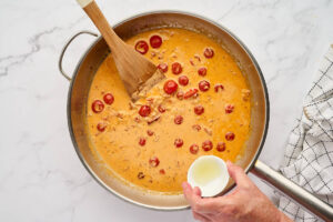 Adding lemon juice to the cream sauce.