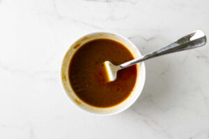 Stirring the miso glaze in a dish.