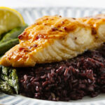 A serving of baked halibut topped with a glossy glaze.