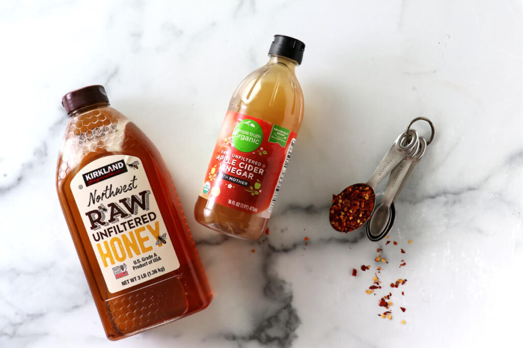Ingredients used to make spicy honey with dried chili flakes.