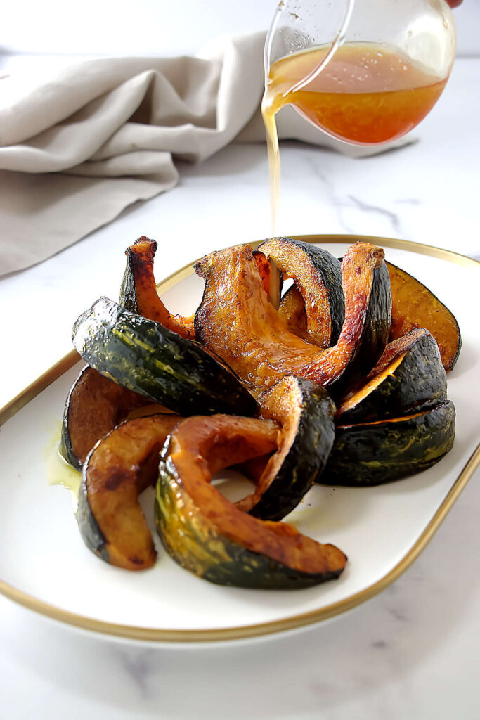 Drizzling hot honey over kabocha squash.