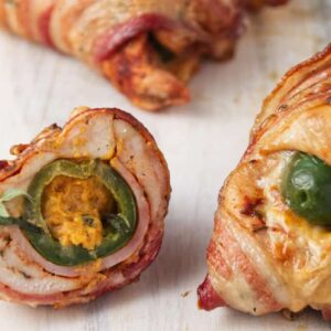 Bacon-wrapped chicken stuffed with jalape&ntilde;o and cheese, sliced open.