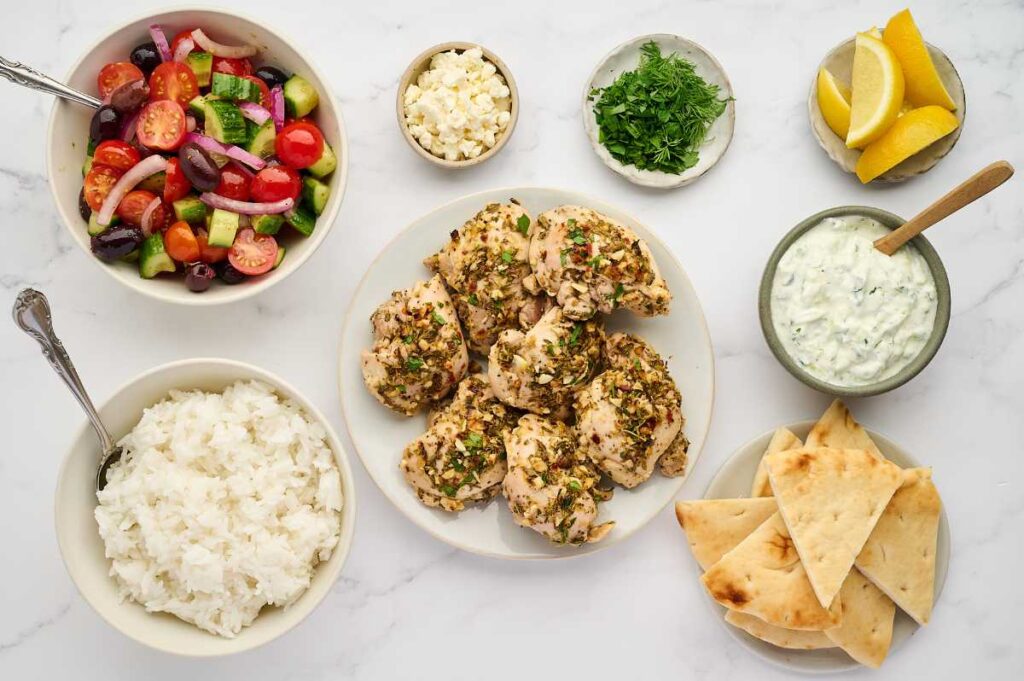 Greek lemon chicken sliced for serving over rice bowls.