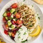 Fresh toppings for Mediterranean chicken bowls with cucumber, tomatoes, olives, and feta.