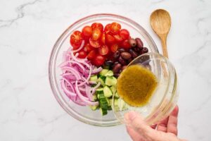 Rice bowl topped with Greek chicken, Kalamata olives, feta, and tomatoes.