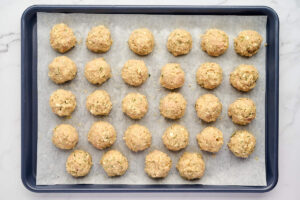 Greek chicken meatballs ready to serve with pita and tzatziki.