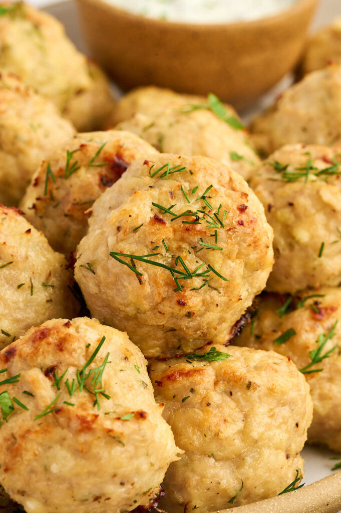 Greek-style chicken meatballs arranged on a serving platter.