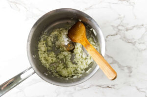 Onion and garlic cooking in olive oil for homemade Greek lemon rice.