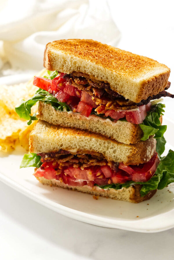 Close-up of a homemade bacon lettuce tomato sandwich on toasted bread.