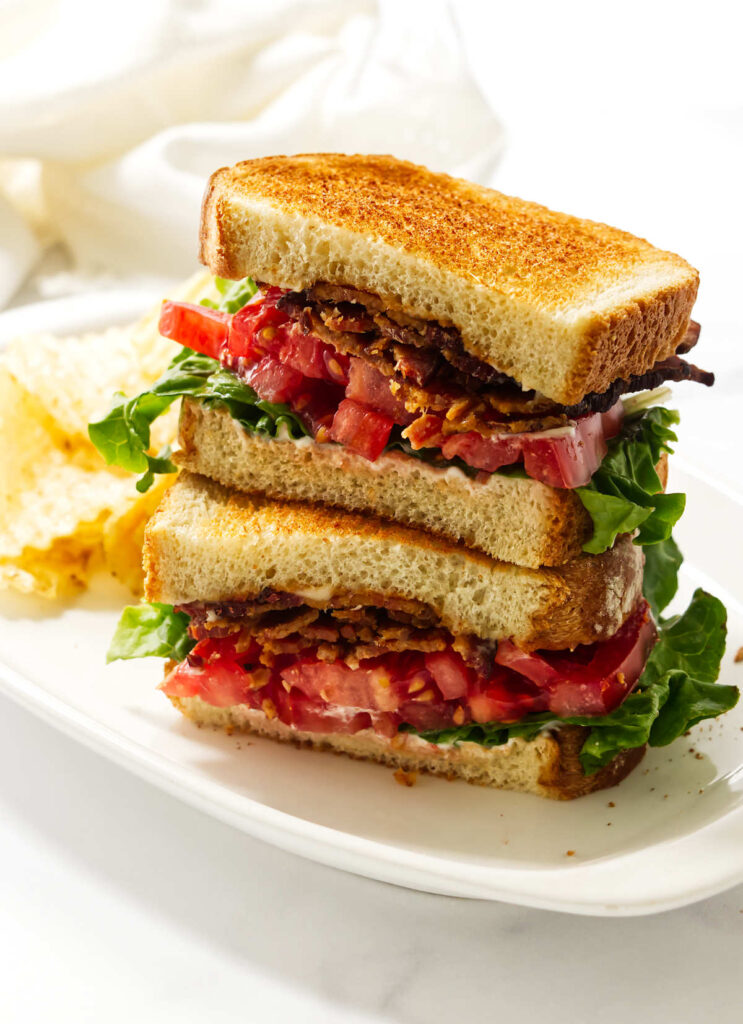 Close-up of a homemade bacon lettuce tomato sandwich on toasted bread.