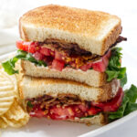 How to make a BLT sandwich with layered lettuce, tomatoes, bacon, and mayonnaise.