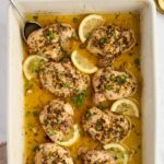 Lemon Greek chicken arranged on a serving platter with fresh parsley.