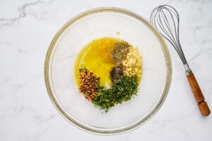 Fresh herbs, lemon, garlic, and olive oil for Greek lemon chicken.