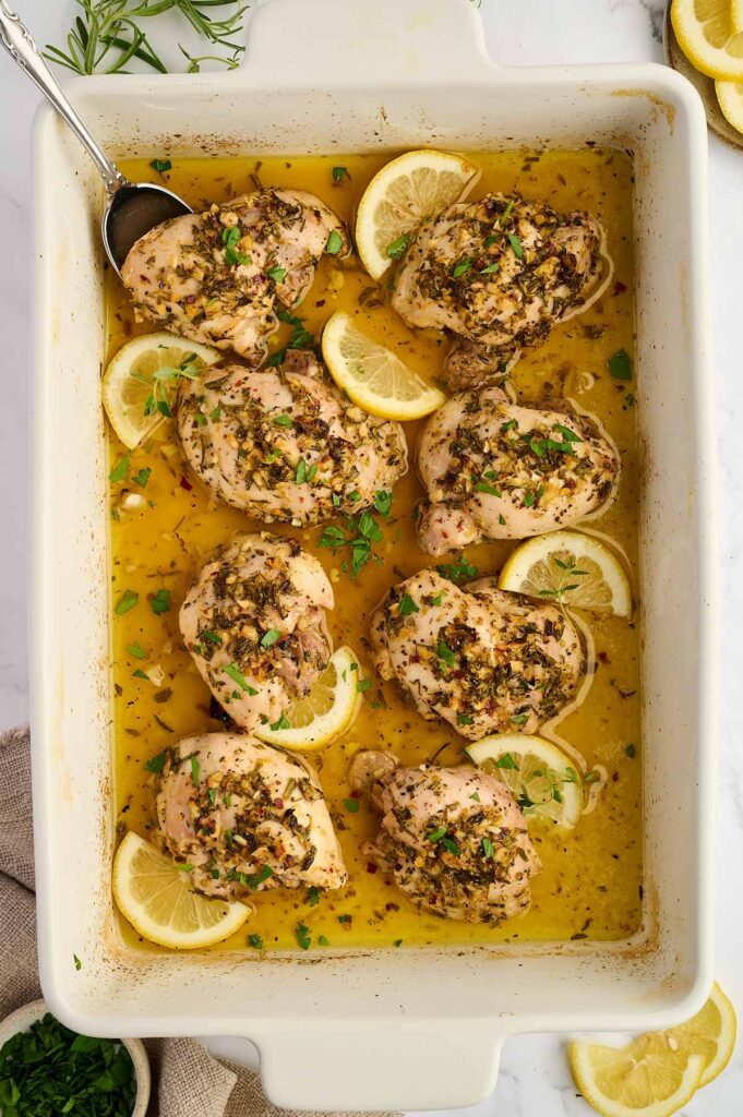 Fresh lemon, garlic, olive oil, and herbs for Greek chicken marinade.