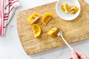 Scooping the lemon pulp out of a preserved lemon.