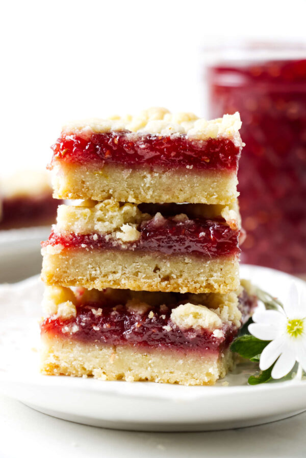 Raspberry crumb bars with golden topping and raspberry jam filling.