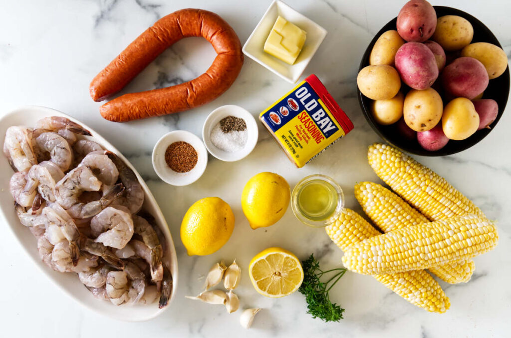 Sheet pan shrimp boil ingredients ready for staged oven roasting.