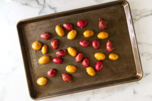 Oven baked shrimp boil with golden potatoes and buttery corn.