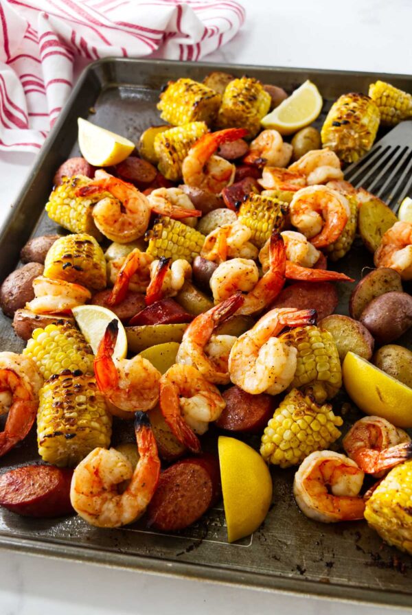 Sheet pan shrimp boil finished with fresh lemon juice and parsley.