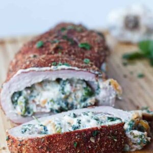 Sliced stuffed pork tenderloin with creamy spinach, cheese, and herbs.