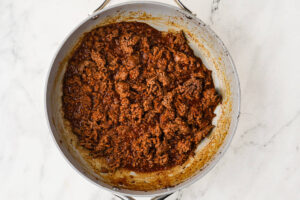 Seasoned ground beef taco meat simmered in a skillet.