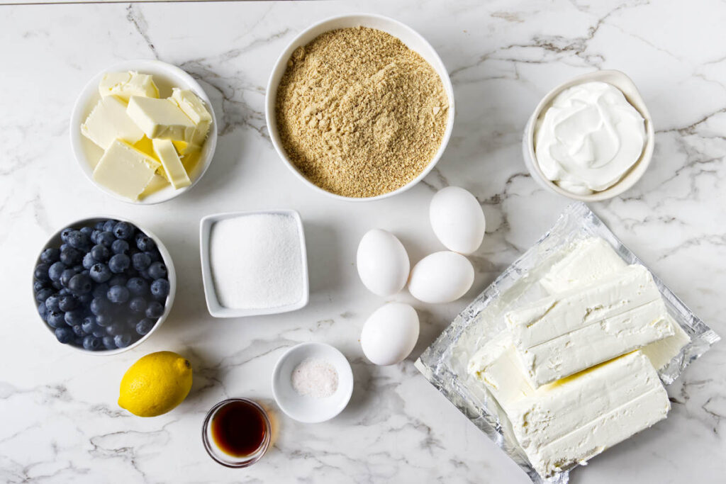 Ingredients for lemon blueberry cheesecake bars with cream cheese and blueberries.