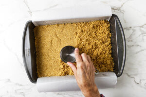 Graham cracker crust pressed into a pan.