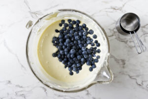 Folding the blueberries into the cheesecake filling.