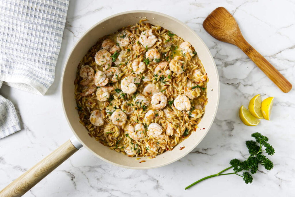 One pot lemon shrimp orzo finished with fresh parsley.