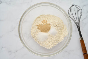 Flour, yeast, sugar, and salt in a mixing bowl for garlic knots.