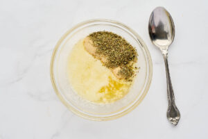Melted butter, minced garlic, garlic powder, and Italian seasoning for stromboli topping.
