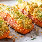 Baked salmon fillets with crispy panko herb crust and fresh dill.