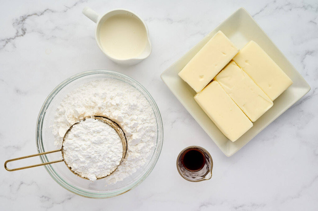 Ingredients for baking including flour, butter, milk, and vanilla extract.