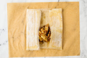 Filo dough partially folded over spiced apple filling.