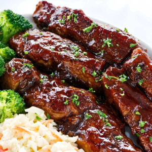 Barbecue ribs served with broccoli and coleslaw.